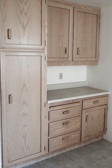 Light wood cabinets with drawers and a gray countertop