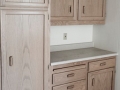 Light wood cabinets with drawers and a gray countertop