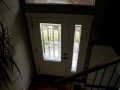 White front door with decorative glass panel and matching narrow sidelight